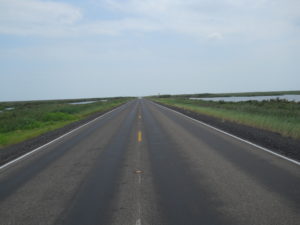 Photo of a highway stretching towards the horizon